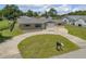 Cozy home with manicured lawn, showcasing an inviting driveway and neat landscaping at 2416 Pine Tree Dr, Edgewater, FL 32141
