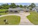 Charming home with a well-maintained lawn, featuring a tidy driveway and inviting curb appeal at 2416 Pine Tree Dr, Edgewater, FL 32141
