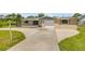 Cozy home with a manicured lawn and driveway, creating an inviting first impression at 2416 Pine Tree Dr, Edgewater, FL 32141