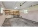 Clean garage featuring built-in shelving, workbench, and good lighting for all your projects at 2416 Pine Tree Dr, Edgewater, FL 32141