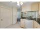Bright kitchen with tile flooring, white cabinets, stainless appliances, and a breakfast bar at 2416 Pine Tree Dr, Edgewater, FL 32141