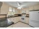 Updated kitchen featuring white cabinets, granite countertops, tile flooring, and stainless steel appliances at 2416 Pine Tree Dr, Edgewater, FL 32141