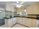 Bright kitchen with white cabinets, stainless steel appliances, granite counters and breakfast bar at 2416 Pine Tree Dr, Edgewater, FL 32141