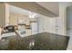 Bright kitchen with tile floors, white appliances, and a granite countertop breakfast bar at 2416 Pine Tree Dr, Edgewater, FL 32141