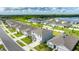 An aerial view of a two-story home in a neighborhood with a view of a lake in the distance at 2667 Neverland Dr, New Smyrna Beach, FL 32168