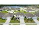 Aerial view of a neighborhood with houses and a pond, on a sunny day at 2667 Neverland Dr, New Smyrna Beach, FL 32168