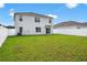 Backyard with well-maintained lawn, and a white fence at 2667 Neverland Dr, New Smyrna Beach, FL 32168