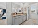 Modern bathroom featuring double vanity, marble countertop, neutral tile and walk in closet at 2667 Neverland Dr, New Smyrna Beach, FL 32168