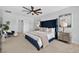 Bedroom features a comfortable bed with a tall headboard, soft lighting, and neutral toned carpet at 2667 Neverland Dr, New Smyrna Beach, FL 32168