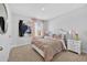 Bedroom with a comfortable bed, soft pink curtains, and bright natural light at 2667 Neverland Dr, New Smyrna Beach, FL 32168