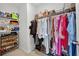 Walk in closet with custom shelving, shoe rack and rod for hanging an expansive wardrobe at 2667 Neverland Dr, New Smyrna Beach, FL 32168