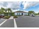 Community clubhouse with palm trees, ample parking, and easy access to community amenities at 2667 Neverland Dr, New Smyrna Beach, FL 32168