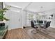 Dining room with hardwood floors, modern light fixture and a glass table at 2667 Neverland Dr, New Smyrna Beach, FL 32168