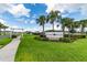 Coastal Woods community entrance sign surrounded by lush landscaping and palm trees at 2667 Neverland Dr, New Smyrna Beach, FL 32168