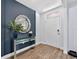 Inviting entryway featuring wood-look floors, decor, stylish table and decorative mirror at 2667 Neverland Dr, New Smyrna Beach, FL 32168
