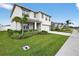Two-story home featuring an attached two-car garage, well-maintained lawn, and front porch at 2667 Neverland Dr, New Smyrna Beach, FL 32168
