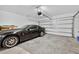 Garage interior with concrete flooring, black sports car and overhead door at 2667 Neverland Dr, New Smyrna Beach, FL 32168