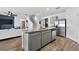Open kitchen concept with stainless steel appliances, island, and bar seating at 2667 Neverland Dr, New Smyrna Beach, FL 32168
