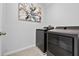 Laundry room with modern front-loading washer and dryer at 2667 Neverland Dr, New Smyrna Beach, FL 32168