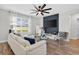 Bright living room with large window, plush sofa, and modern decor at 2667 Neverland Dr, New Smyrna Beach, FL 32168