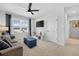 Comfortable living room with neutral carpet, bright window and comfortable seating at 2667 Neverland Dr, New Smyrna Beach, FL 32168