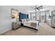 Spacious main bedroom with a tufted headboard, ceiling fan, and natural light at 2667 Neverland Dr, New Smyrna Beach, FL 32168