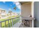 Cozy balcony with a round table and chairs overlooking the lush lawn and street at 2898 Ocean Shore Blvd # 5020, Ormond Beach, FL 32176