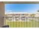 Balcony view of a two-story building and well-maintained green space at 2898 Ocean Shore Blvd # 5020, Ormond Beach, FL 32176