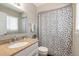 Bathroom with a granite countertop vanity and a black and white polka dot shower curtain at 2898 Ocean Shore Blvd # 5020, Ormond Beach, FL 32176