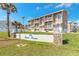 Inviting Sand Dunes community with well-maintained landscaping and charming dolphin statues, exuding coastal charm at 2898 Ocean Shore Blvd # 5020, Ormond Beach, FL 32176