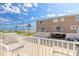 View of a tan exterior and ocean with a balcony that has two seats at 2898 Ocean Shore Blvd # 5020, Ormond Beach, FL 32176