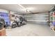Spacious garage featuring a motorcycle, tool storage, and ample room for projects at 2898 Ocean Shore Blvd # 5020, Ormond Beach, FL 32176