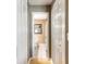 A hallway leading to a bathroom with neutral colors and tile flooring at 2898 Ocean Shore Blvd # 5020, Ormond Beach, FL 32176