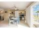 Bright living space with a built-in office area, dining table, and access to a balcony with beach views at 2898 Ocean Shore Blvd # 5020, Ormond Beach, FL 32176