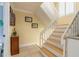 Bright foyer staircase with neutral color palette, leading to the upper level of the residence at 2898 Ocean Shore Blvd # 5020, Ormond Beach, FL 32176