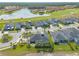 Aerial view of neighborhood homes situated near a golf course and lake, highlighting community charm and waterfront views at 2939 Bella Flore Ter, New Smyrna Beach, FL 32168