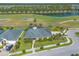 Beautiful aerial view of a home with lush landscaping, screened pool, and golf course frontage, providing a scenic and private setting at 2939 Bella Flore Ter, New Smyrna Beach, FL 32168