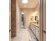 Elegant bathroom with double vanity, granite countertop, and a walk-in shower and closet at 2939 Bella Flore Ter, New Smyrna Beach, FL 32168
