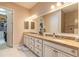 Bathroom with granite countertop, double sinks, and a view into the large walk-in closet at 2939 Bella Flore Ter, New Smyrna Beach, FL 32168