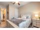 Comfortable bedroom with a ceiling fan, luxury bedding, and a view to the en suite bath at 2939 Bella Flore Ter, New Smyrna Beach, FL 32168
