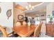 Warm dining area featuring a wooden table, chandelier, and decor that leads into the living room and kitchen at 2939 Bella Flore Ter, New Smyrna Beach, FL 32168