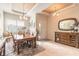 Cozy dining area with a wooden table, chandelier lighting, neutral colors, and tile flooring at 2939 Bella Flore Ter, New Smyrna Beach, FL 32168