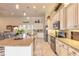 Bright, open kitchen featuring a large center island with seating, white cabinets, and modern appliances at 2939 Bella Flore Ter, New Smyrna Beach, FL 32168