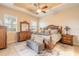 Serene main bedroom with wood furniture, a ceiling fan, and natural light from bright windows at 2939 Bella Flore Ter, New Smyrna Beach, FL 32168