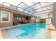 Stunning screened-in pool with comfortable seating and outdoor kitchen at 2939 Bella Flore Ter, New Smyrna Beach, FL 32168