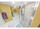 Bright bathroom with a walk-in shower and a white bathtub at 2967 S Atlantic Ave # 508, Daytona Beach, FL 32118