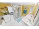 Bright bathroom with a shower, white tiled floors, and a double vanity at 2967 S Atlantic Ave # 508, Daytona Beach, FL 32118