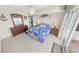 Bedroom with a balcony access, a dresser and two nightstands at 2967 S Atlantic Ave # 508, Daytona Beach, FL 32118
