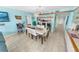 Bright dining area with a white dining table, bar stools, and coastal-themed decor at 2967 S Atlantic Ave # 508, Daytona Beach, FL 32118