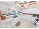 Bright kitchen with white cabinetry, a breakfast bar, and a fun decorative ceiling at 2967 S Atlantic Ave # 508, Daytona Beach, FL 32118